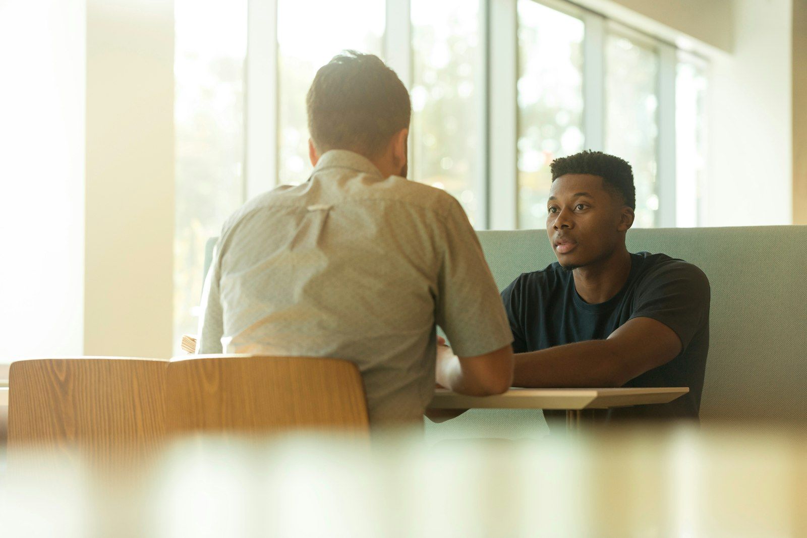 Two colleagues in conversation across a table